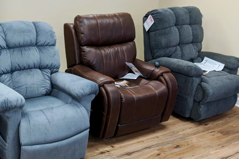 Three mobility lift chairs on display in showroom