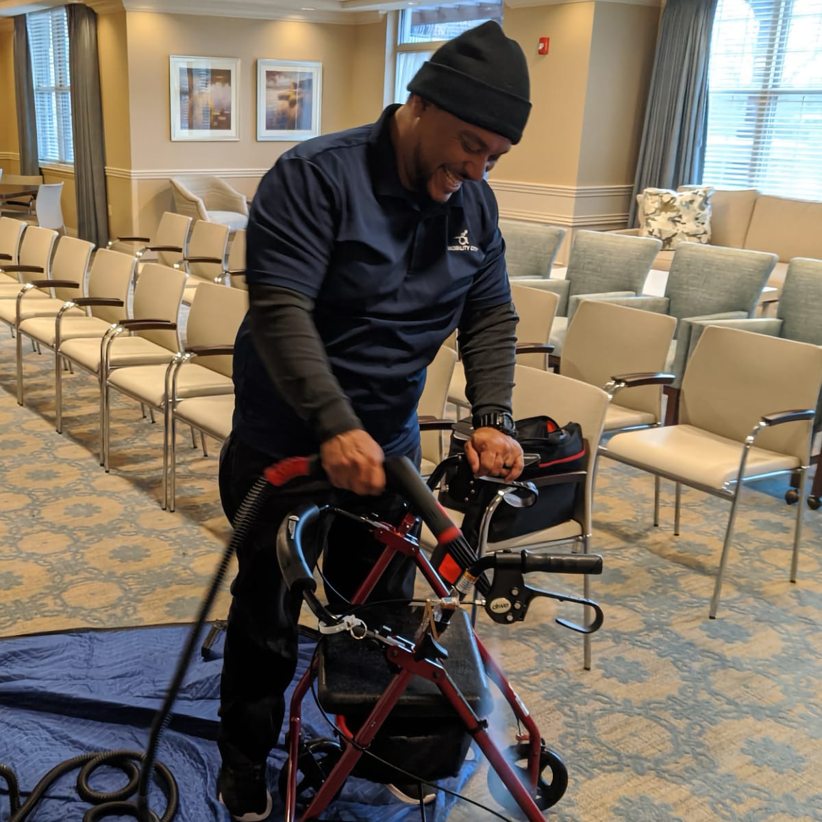 Andre; Midwest Mobility's Service Manager. Smiling man cleaning walker in retirement home